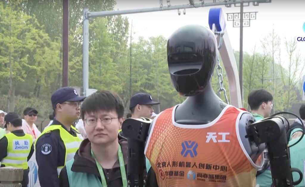 Who won the first half marathon where the robots challenged humans